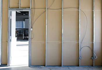 Commercial drywall installation with metal framing and electrical conduit integration in San Gabriel